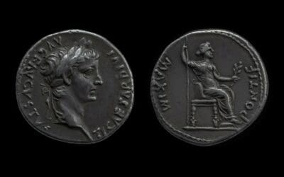 The Front and back of an ancient Roman denarius (coin) seated on a black background