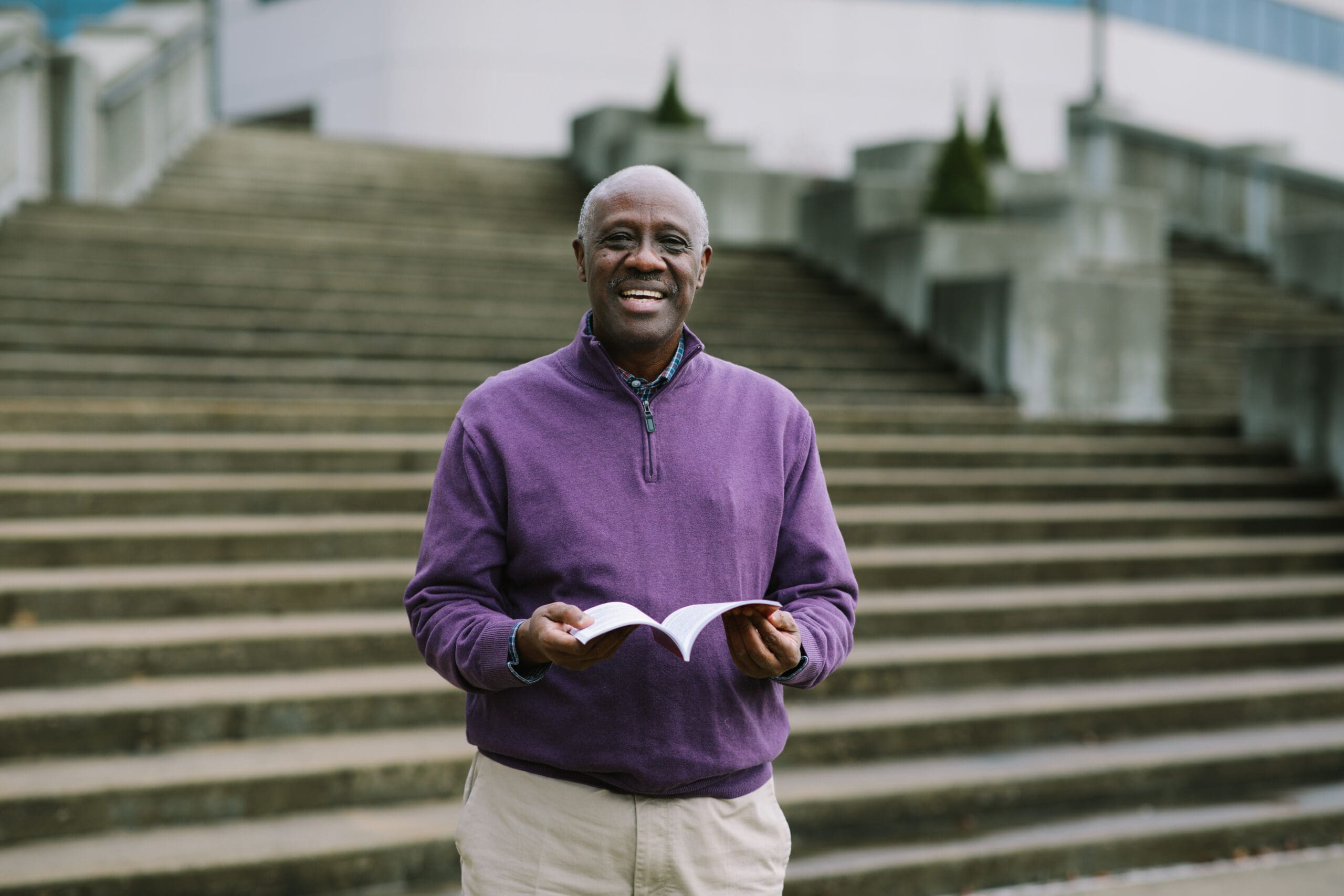 Portrait of Victor holding a Kinyamulenge Bible