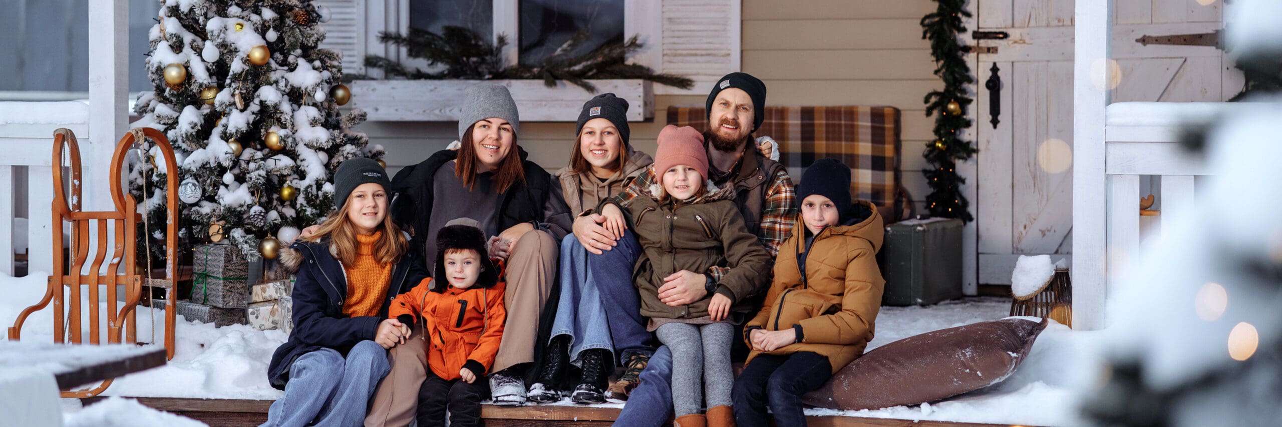 A large family sits on the porch for christmas